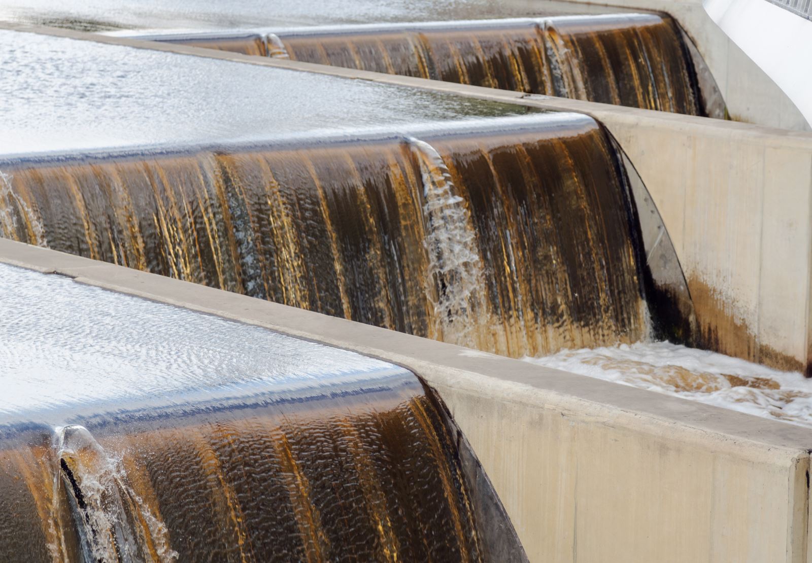 water flowing in man-made rectangular channels with 2 foot high waterfalls in each channel